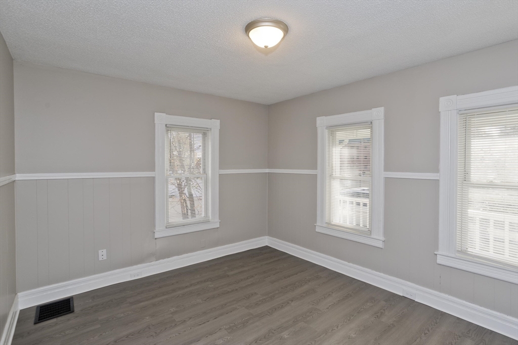 81 Hayden Avenue Springfield, MA 01109 - Photo 27 of 34 an empty room with wooden floor and windows