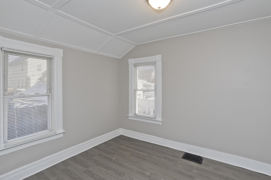 81 Hayden Avenue Springfield, MA 01109 - Photo 28 of 34 an empty room with wooden floor and windows