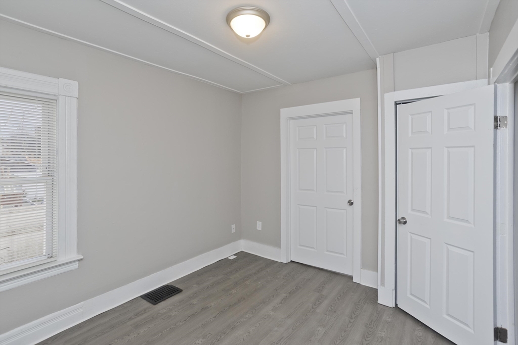 81 Hayden Avenue Springfield, MA 01109 - Photo 29 of 34 an empty room with wooden floor and windows