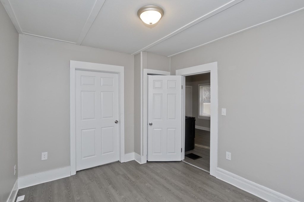 81 Hayden Avenue Springfield, MA 01109 - Photo 30 of 34 an empty room with wooden floor and closet