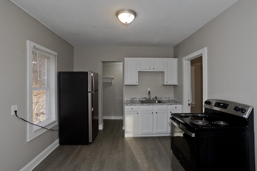 81 Hayden Avenue Springfield, MA 01109 - Photo 5 of 34 a kitchen with granite countertop a refrigerator stove and sink