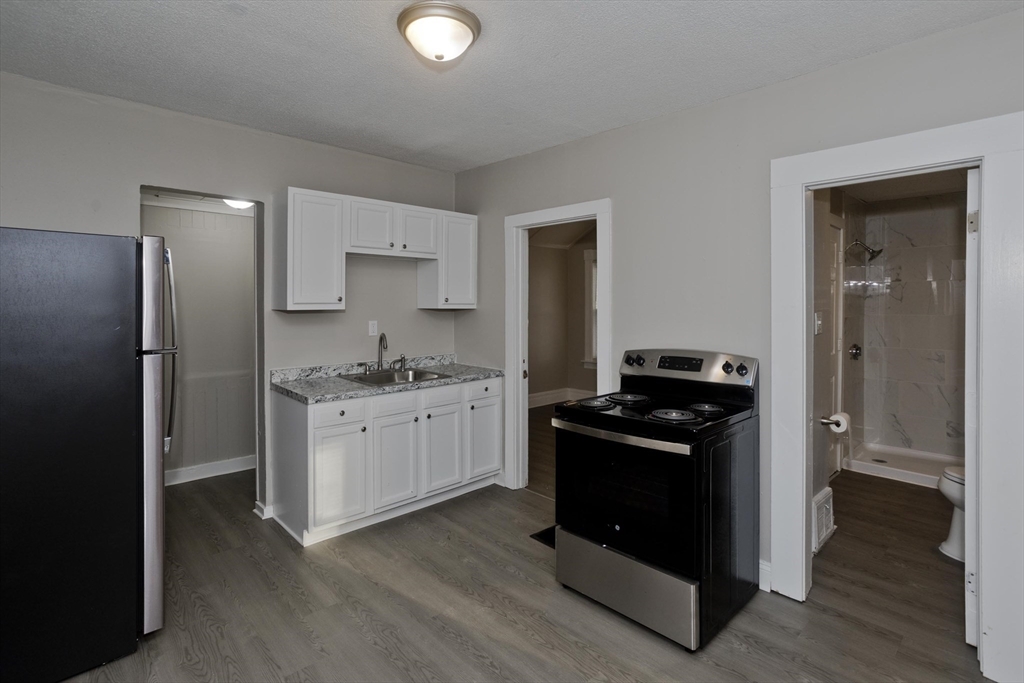81 Hayden Avenue Springfield, MA 01109 - Photo 6 of 34 a kitchen with a stove and a refrigerator