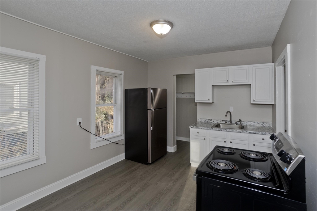 81 Hayden Avenue Springfield, MA 01109 - Photo 7 of 34 a kitchen with a stove and a refrigerator