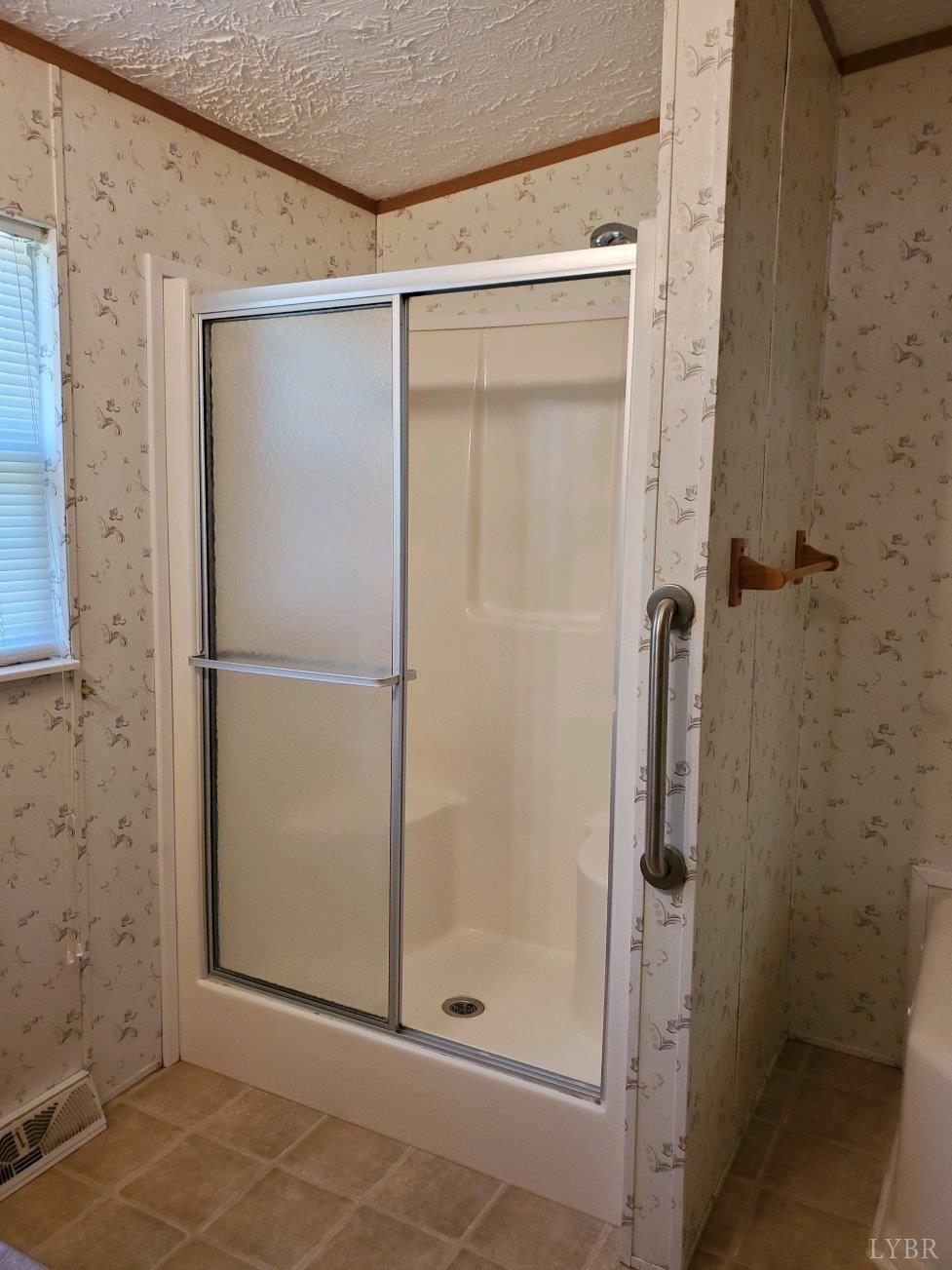 2075 New Bethel Road Meherrin, VA 23954 - Photo 13 of 32 a bathroom with a glass shower door
