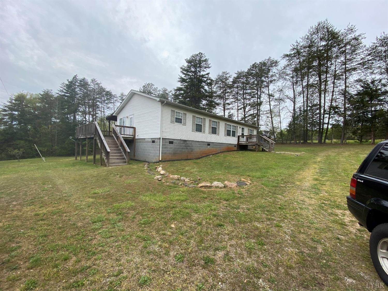 2075 New Bethel Road Meherrin, VA 23954 - Photo 24 of 32 a view of a house with a yard and a large tree