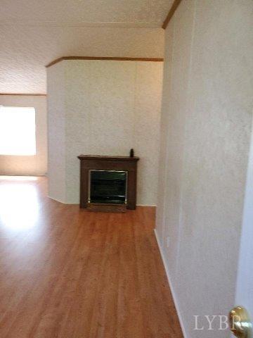 2075 New Bethel Road Meherrin, VA 23954 - Photo 3 of 32 a view of empty room with wooden floor and fireplace