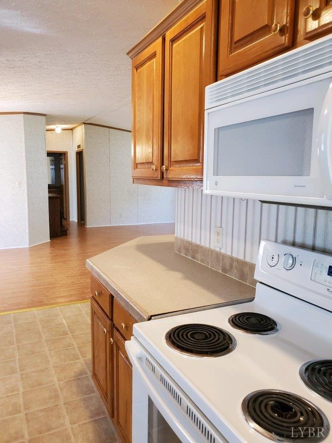 2075 New Bethel Road Meherrin, VA 23954 - Photo 4 of 32 a kitchen with a stove and a microwave