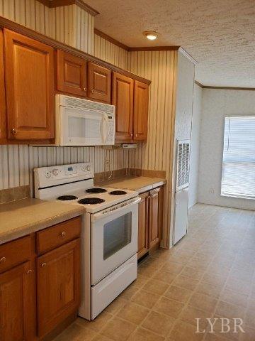 2075 New Bethel Road Meherrin, VA 23954 - Photo 7 of 32 a kitchen with a stove sink and cabinets