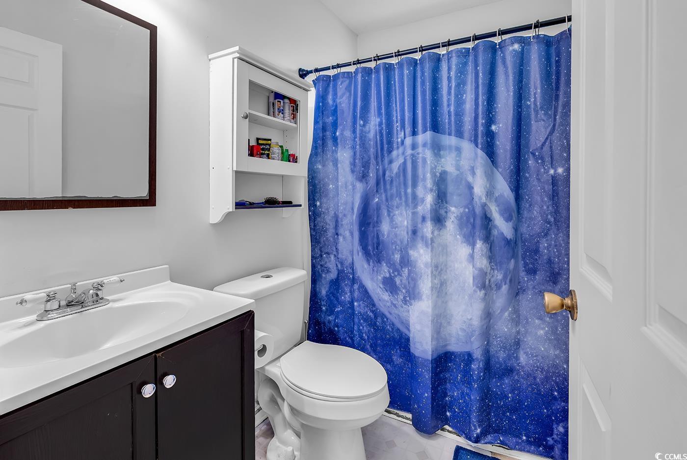 9450 Leeds Circle Myrtle Beach, SC 29588 - Photo 21 of 25 Bathroom with toilet, a shower with shower curtain, and vanity