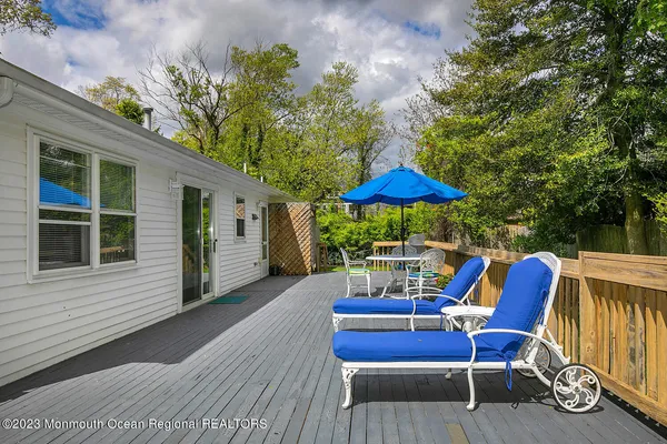 a view of a chairs and table in the back yard