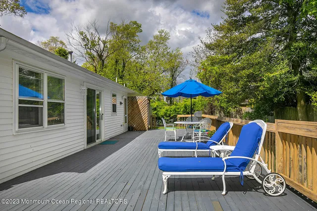 a view of a chairs and table in the back yard