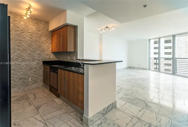 a bathroom with a granite countertop sink and a washing machine