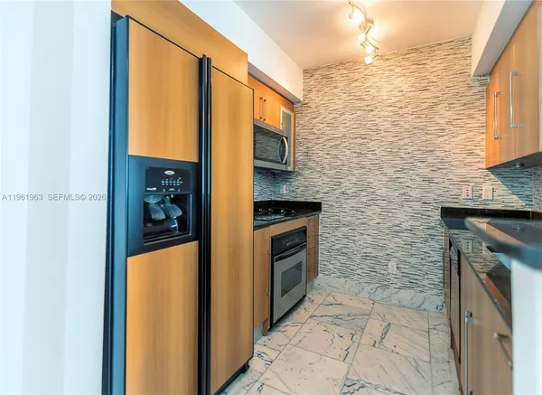 a hallway with a large window and couch