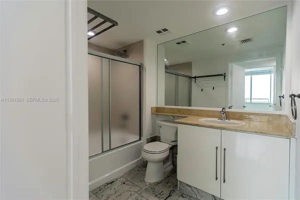 a kitchen with stainless steel appliances a sink stove and cabinets