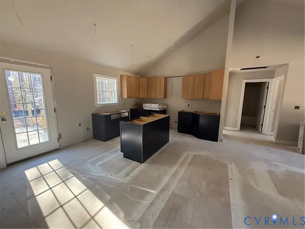 a large kitchen with cabinets and a window