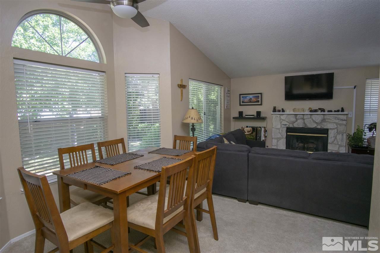 1067 Embassy Way Reno, NV 89523 - Photo 8 of 18 a view of a dining room with furniture window and a fireplace