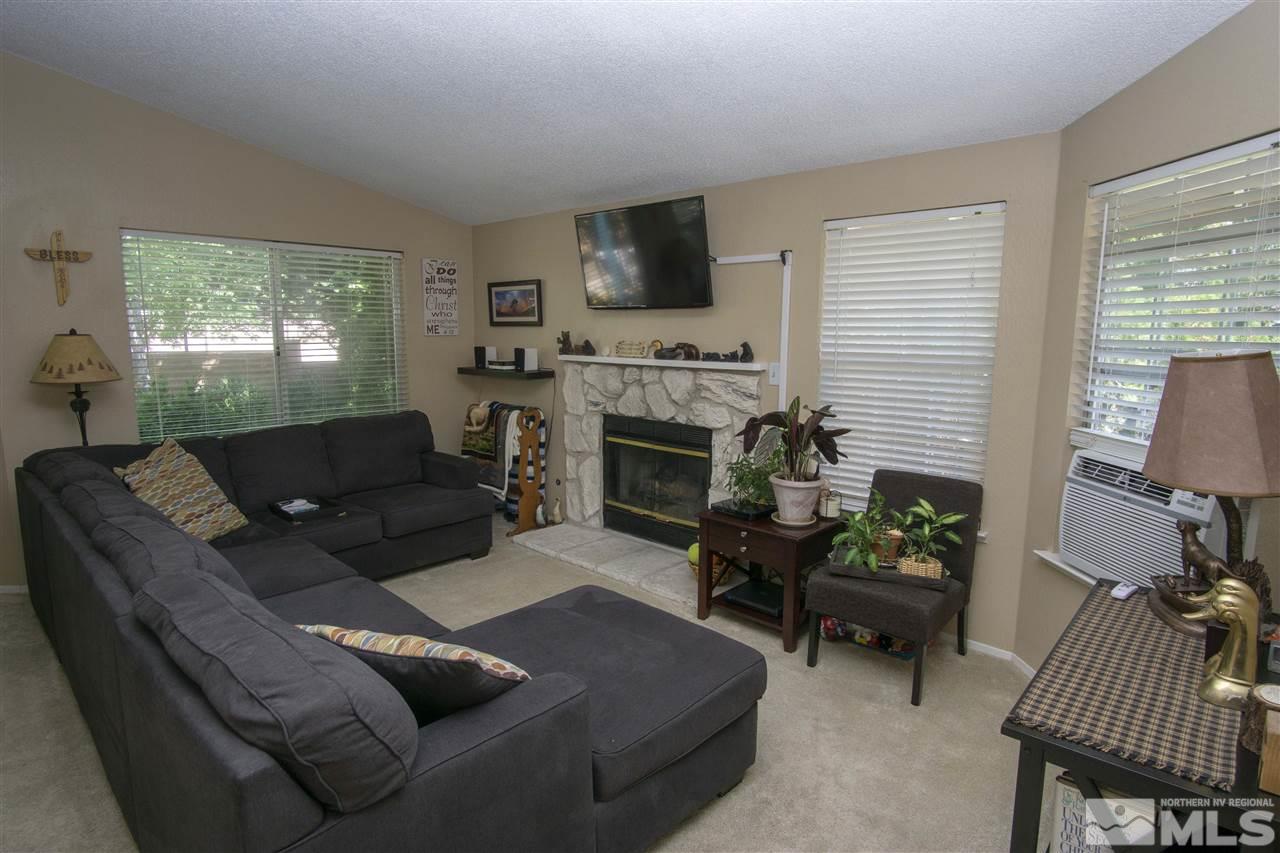 1067 Embassy Way Reno, NV 89523 - Photo 9 of 18 a living room with furniture flat screen tv and a fireplace