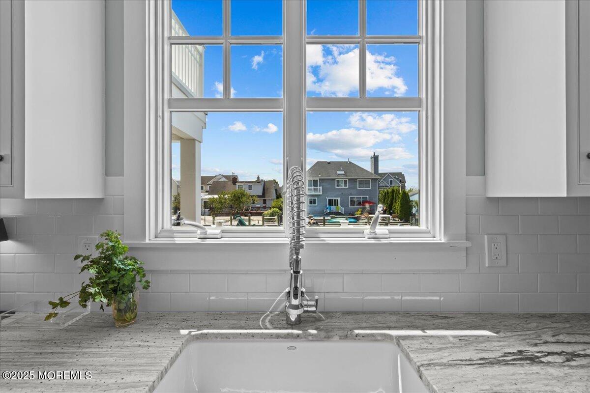 1730 Rue Mirador, Unit WINTER MONTHLY RENTAL Point Pleasant, NJ 08742 - Photo 13 of 72 a vase of flowers sitting on a table next to a window