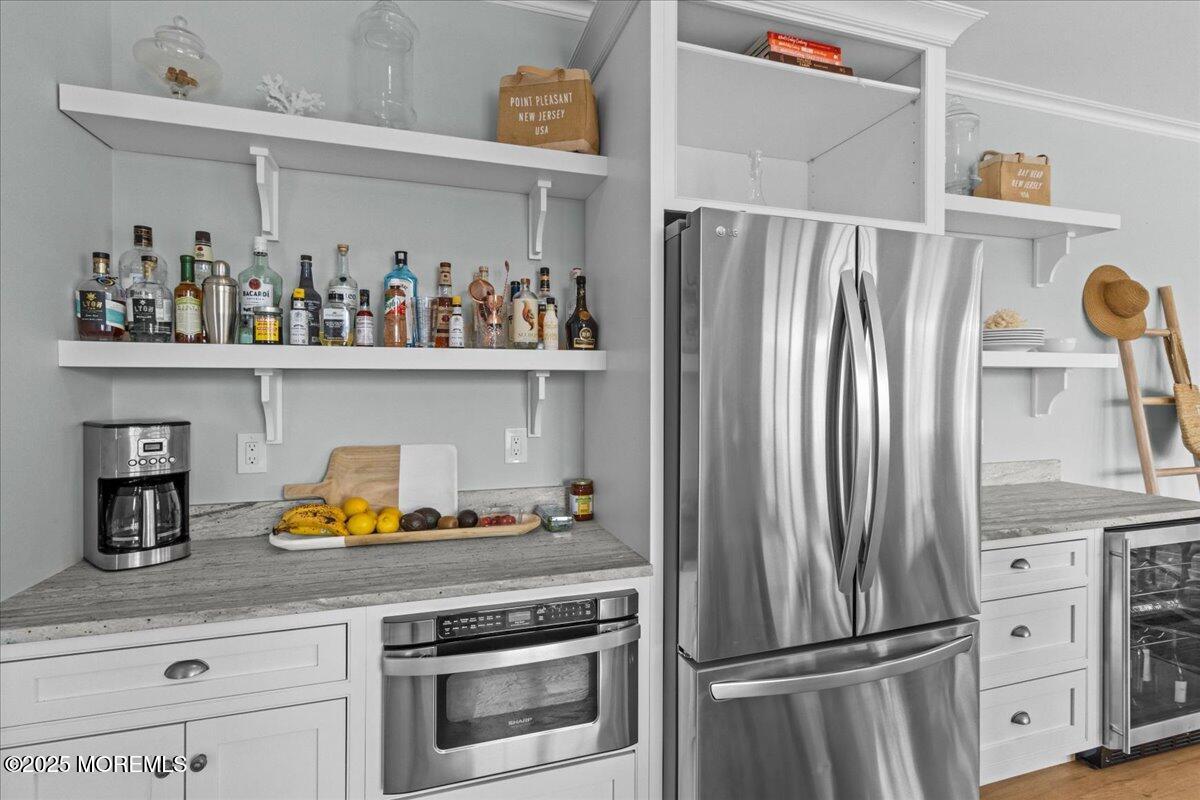 1730 Rue Mirador, Unit WINTER MONTHLY RENTAL Point Pleasant, NJ 08742 - Photo 14 of 72 a kitchen with stainless steel appliances and a refrigerator