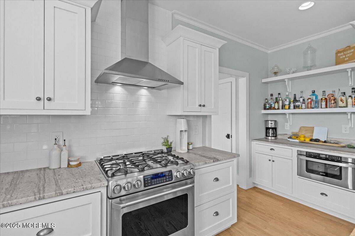 1730 Rue Mirador, Unit WINTER MONTHLY RENTAL Point Pleasant, NJ 08742 - Photo 15 of 72 a kitchen with white cabinets and appliances