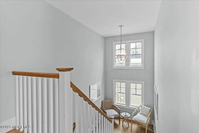 a bathroom with a granite countertop tub double vanity sink and a window