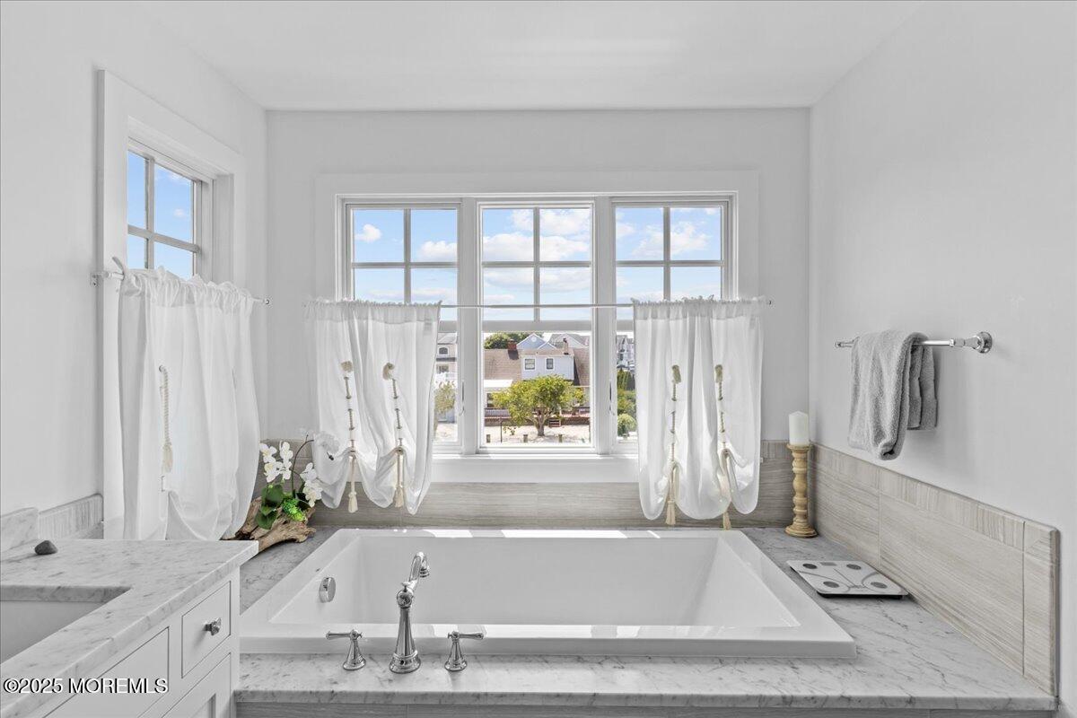 1730 Rue Mirador, Unit WINTER MONTHLY RENTAL Point Pleasant, NJ 08742 - Photo 24 of 72 a bathroom with a tub a sink and a window