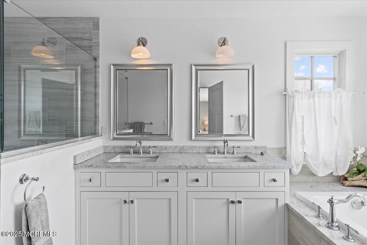 1730 Rue Mirador, Unit WINTER MONTHLY RENTAL Point Pleasant, NJ 08742 - Photo 26 of 72 a bathroom with double sink and a mirror