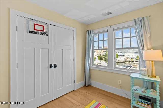 a view of a room with furniture and wooden floor