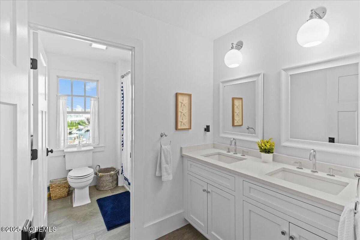 1730 Rue Mirador, Unit WINTER MONTHLY RENTAL Point Pleasant, NJ 08742 - Photo 39 of 72 a bathroom with a double vanity sink and a mirror