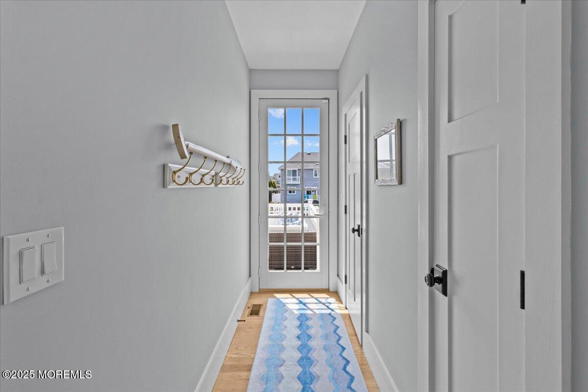1730 Rue Mirador, Unit WINTER MONTHLY RENTAL Point Pleasant, NJ 08742 - Photo 44 of 72 a view of a hallway with wooden floor and a bathroom