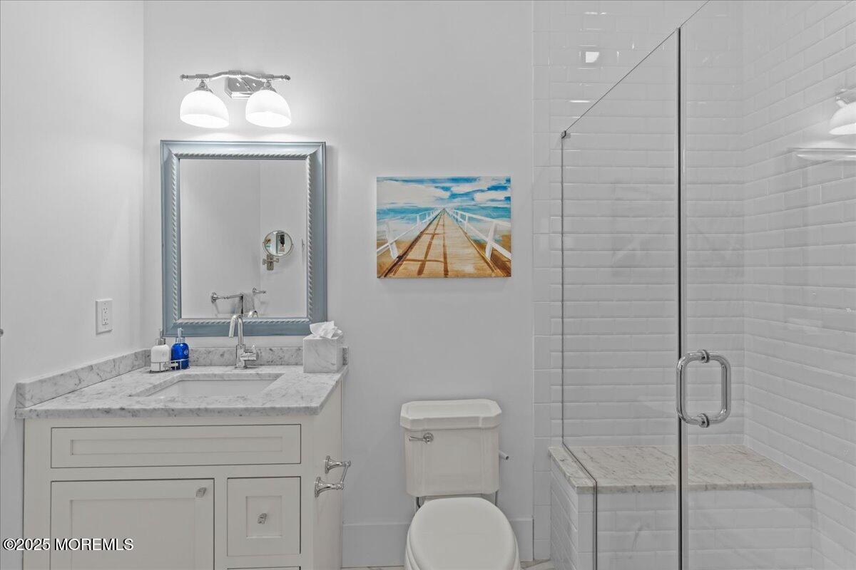 1730 Rue Mirador, Unit WINTER MONTHLY RENTAL Point Pleasant, NJ 08742 - Photo 50 of 72 a bathroom with a toilet a sink and mirror