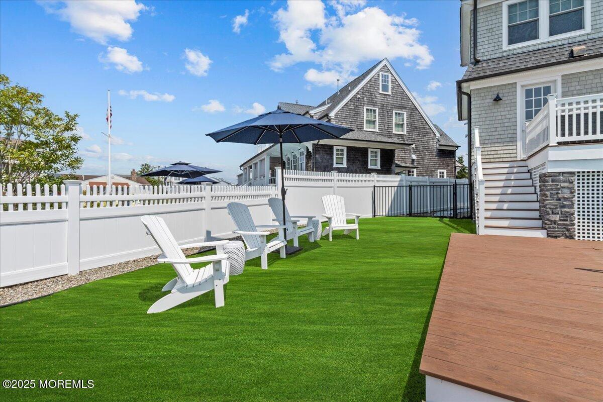 1730 Rue Mirador, Unit WINTER MONTHLY RENTAL Point Pleasant, NJ 08742 - Photo 54 of 72 a front view of a house with a yard table and chairs