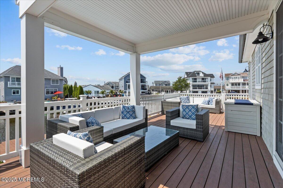 1730 Rue Mirador, Unit WINTER MONTHLY RENTAL Point Pleasant, NJ 08742 - Photo 56 of 72 a view of a balcony with couch and wooden floor