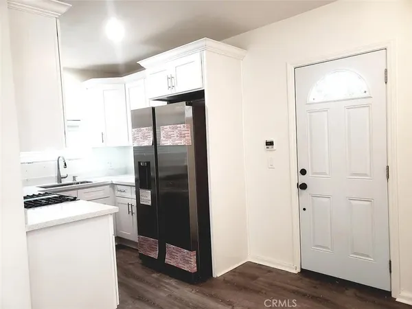 a kitchen with a refrigerator and a stove top oven