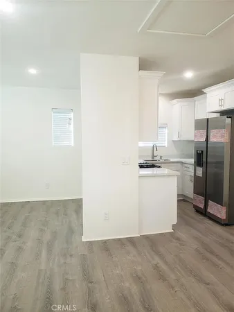 a kitchen with a refrigerator sink and cabinets