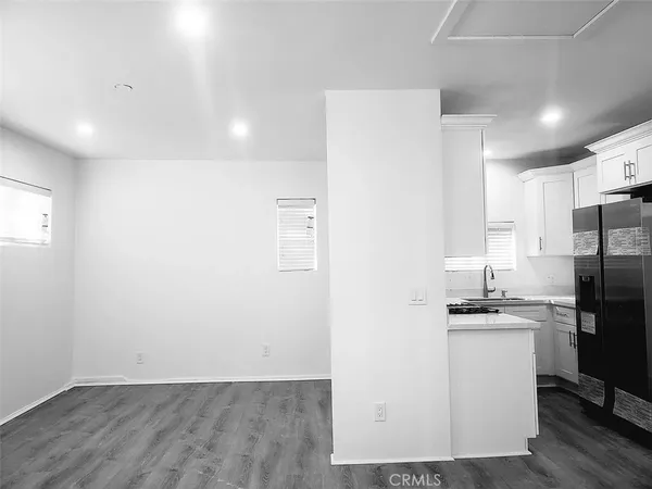 a kitchen with a sink a refrigerator freezer a stove and cabinets
