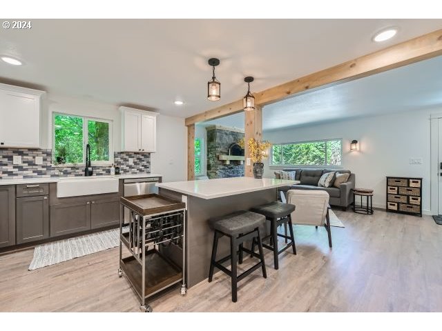 20064 South Central Point Road Oregon City, OR 97045 - Photo 13 of 34 a open dining room with kitchen island furniture a large window and wooden floor