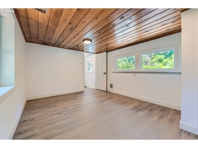 20064 South Central Point Road Oregon City, OR 97045 - Photo 22 of 34 a view of an empty room with wooden floor and a window