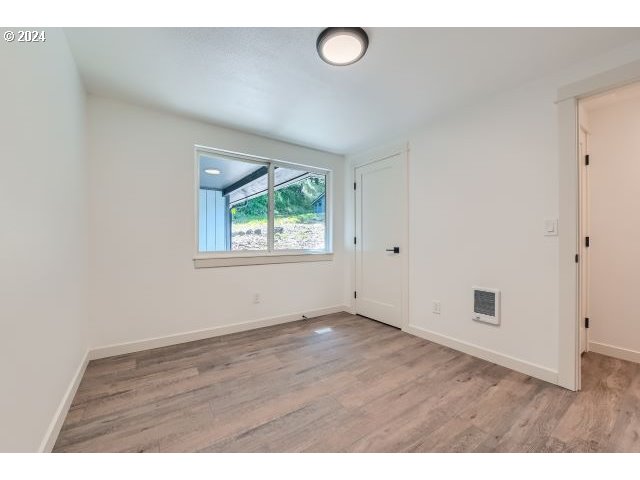 20064 South Central Point Road Oregon City, OR 97045 - Photo 24 of 34 an empty room with wooden floor and windows