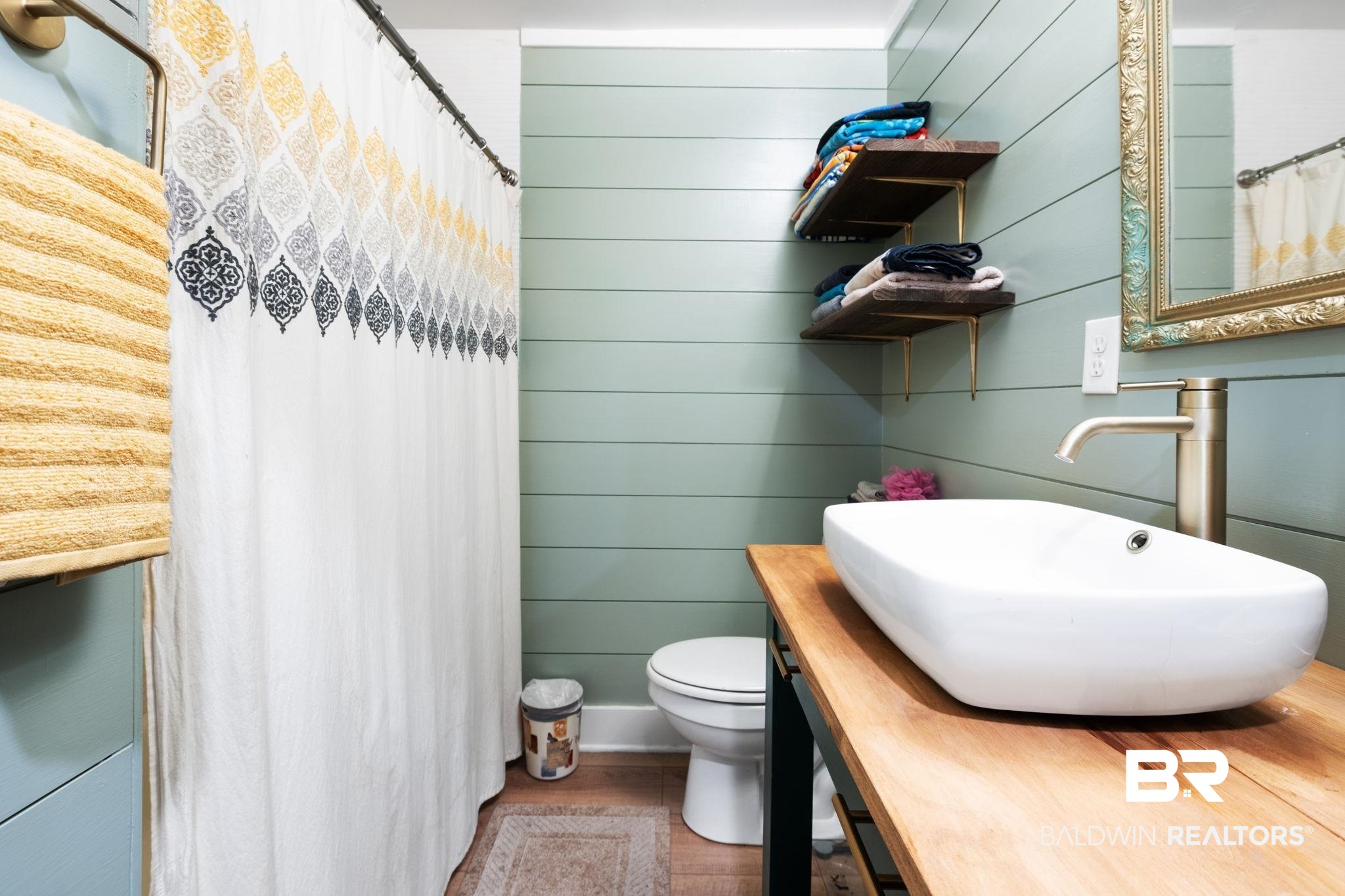 305 Alpine Street Mobile, AL 36611 - Photo 15 of 21 Bathroom with sink, toilet, and wood walls