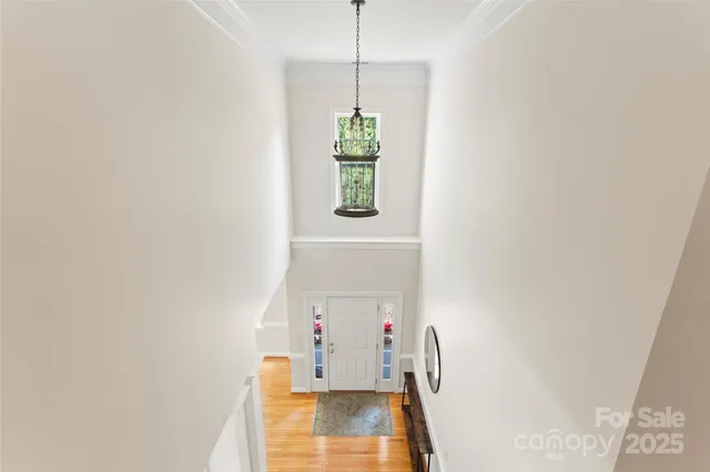 a view of an entryway with wooden floor and a rug