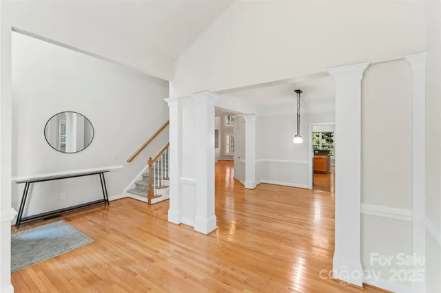 a view of entryway and hall with wooden floor