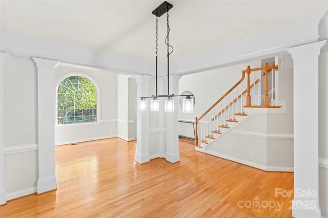 a living room with furniture and a dining table with kitchen view