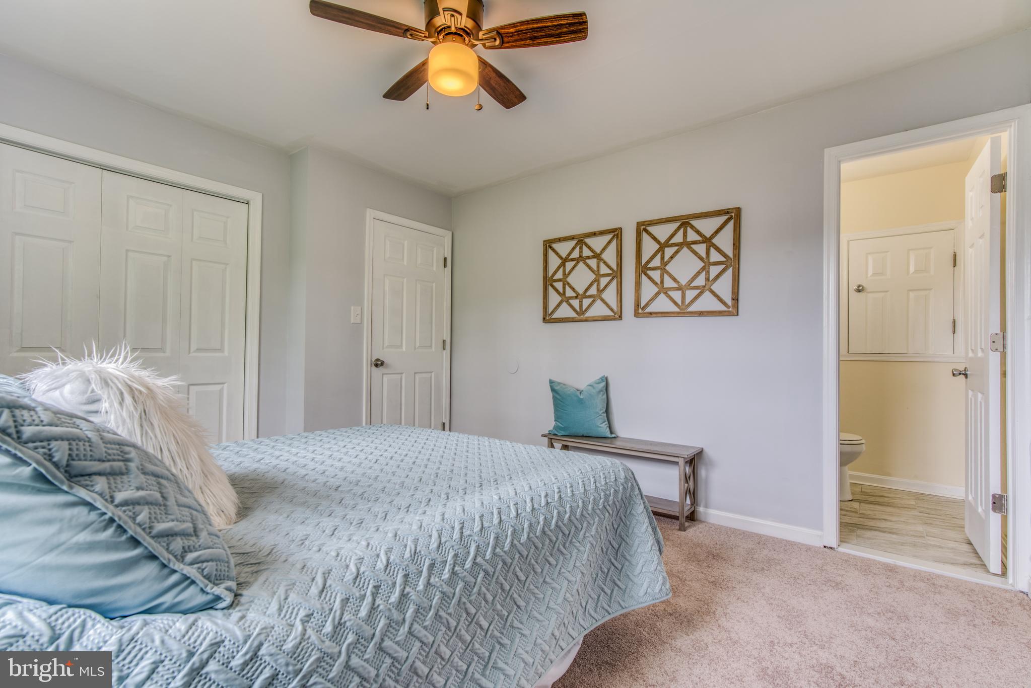 300 Redbud Road Edgewood, MD 21040 - Photo 49 of 65 a bedroom with a bed and a chandelier