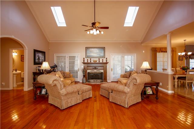 1002 Pleasant Valley Road Greenbrier, TN 37073 - Photo 3 of 20 The living room is so inviting with the newer hardwood floors, gas fireplace, skylights and vaulted ceiling. One set of French doors lead you to the sunroom; the other to the screened in patio.