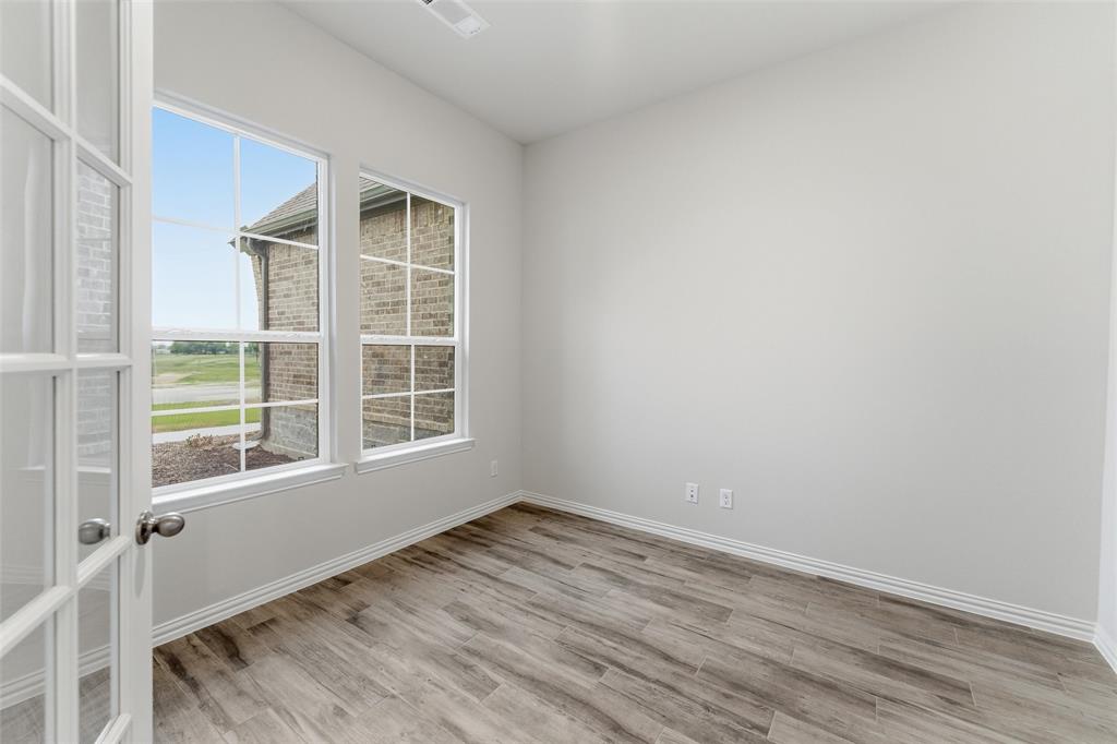 119 Hillview Trail Decatur, TX 76234 - Photo 13 of 30 Room featuring French doors with glass inserts, wood-finish flooring, and white baseboards