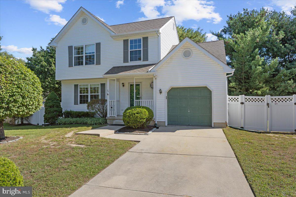 a front view of a house with a garden and plants