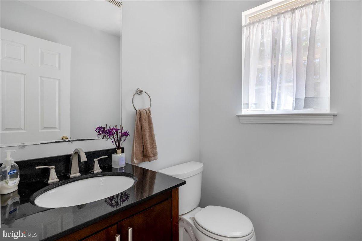 25 Country Club Road Pine Hill, NJ 08021 - Photo 13 of 40 a bathroom with a granite countertop toilet sink and mirror