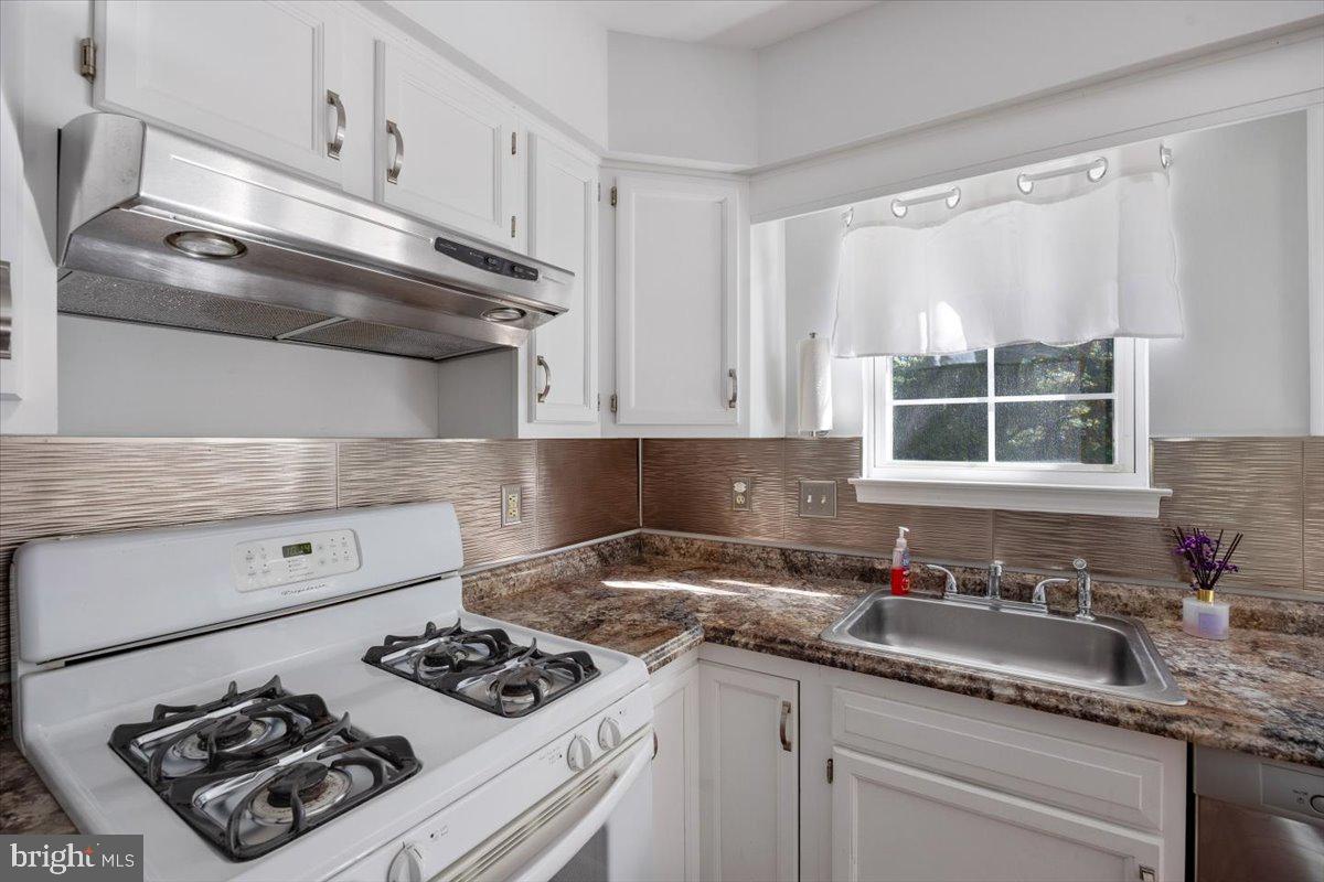 25 Country Club Road Pine Hill, NJ 08021 - Photo 8 of 40 a kitchen with a sink stove and cabinets