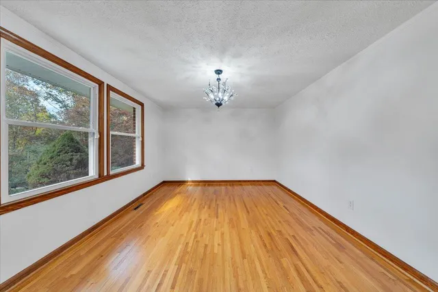 a kitchen with kitchen island granite countertop wooden floors cabinets and dining table
